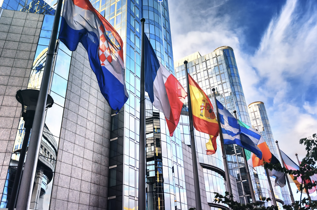 European Union flags waving in front of the Parliament building